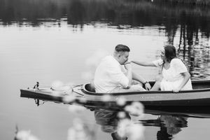 Vintage black and white photograph showing people rowing boats on a tranquil lake in the 1920s era.