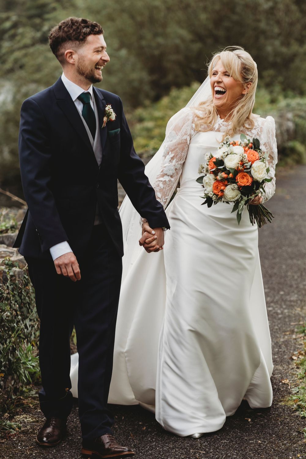 Bride and groom walking together during relaxed Ceredigion West Wales wedding day