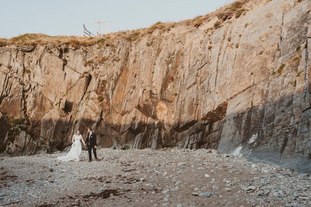 Couple portrait at dramatic coastal cliffs in Ceredigion West Wales wedding photography