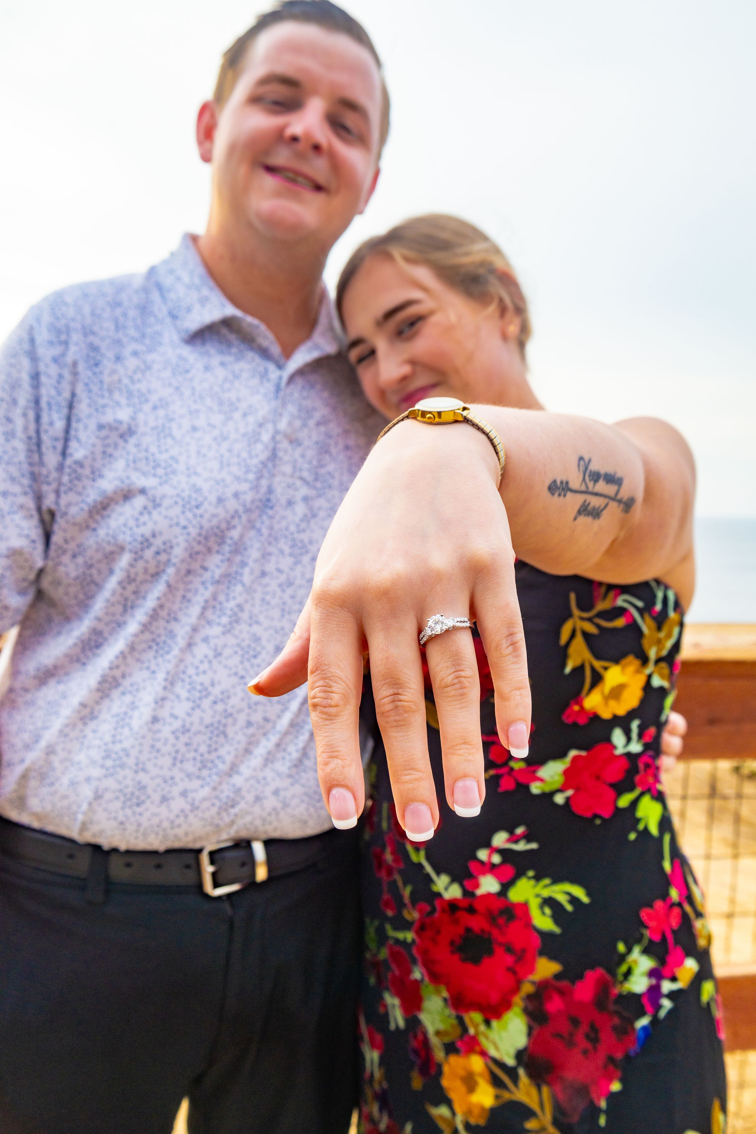 Newly engaged couple showing off the engagement ring to the camera captured by Zeus Holbrook San Diego Wedding Photographer