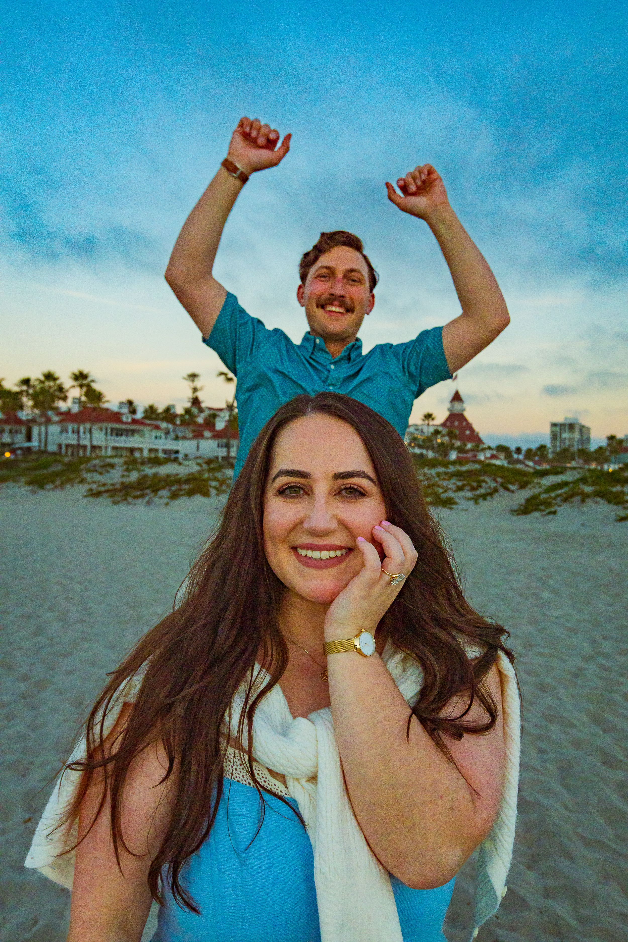 Fun couple portrait at the beach during a sunset engagement session by Zeus Holbrook San Diego Wedding Photographer