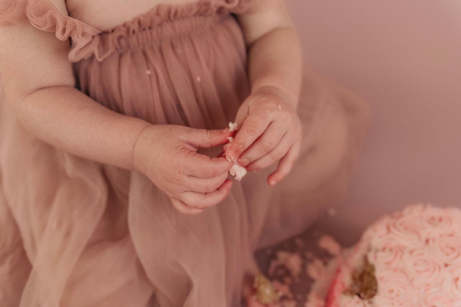 Close-up details of soft pink ruffled fabric in natural light.