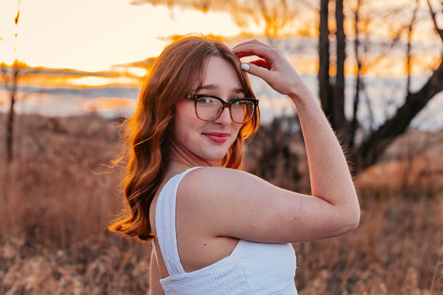 Golden hour outdoor portrait session in natural setting with warm lighting.