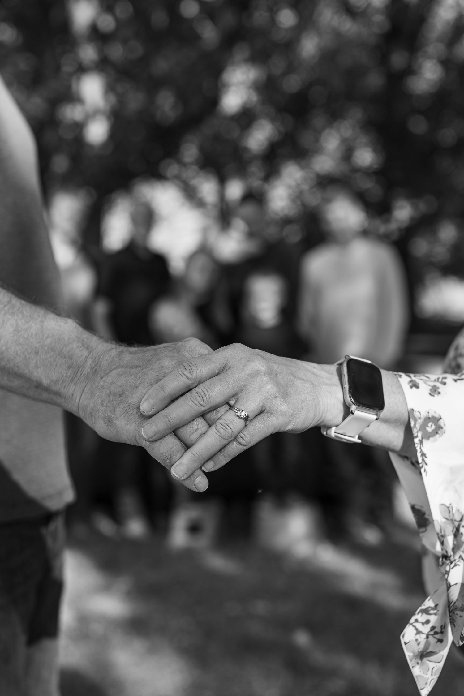 Black and white close-up series of hands reaching toward each other with wedding rings visible.