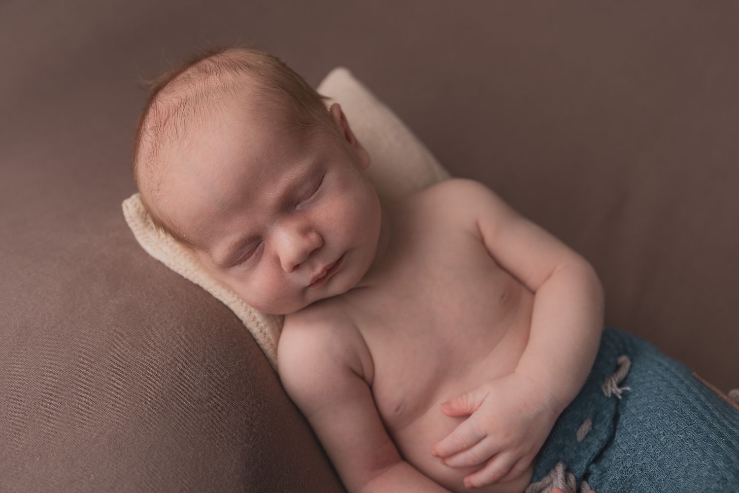 Peaceful newborn photography session with soft natural lighting.