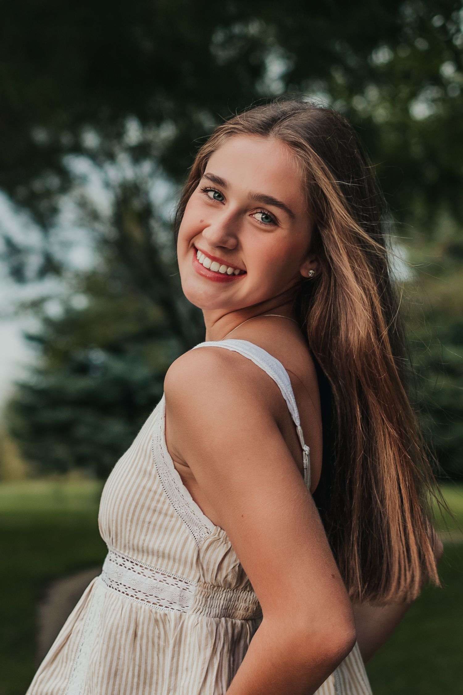 Portrait sequence of a person in a white summer dress posing outdoors.