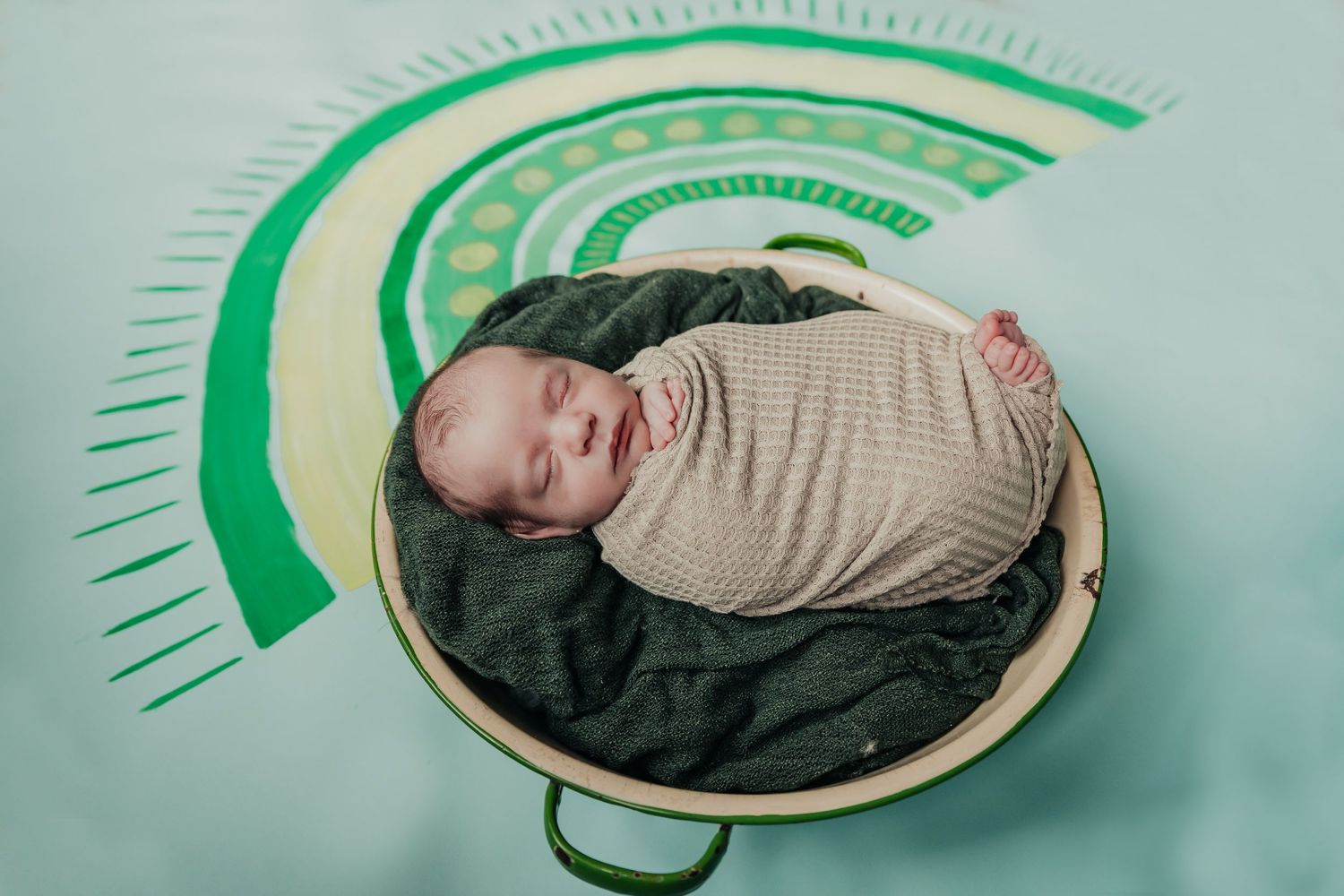Artistic green circle designs on light blue background create geometric pattern.