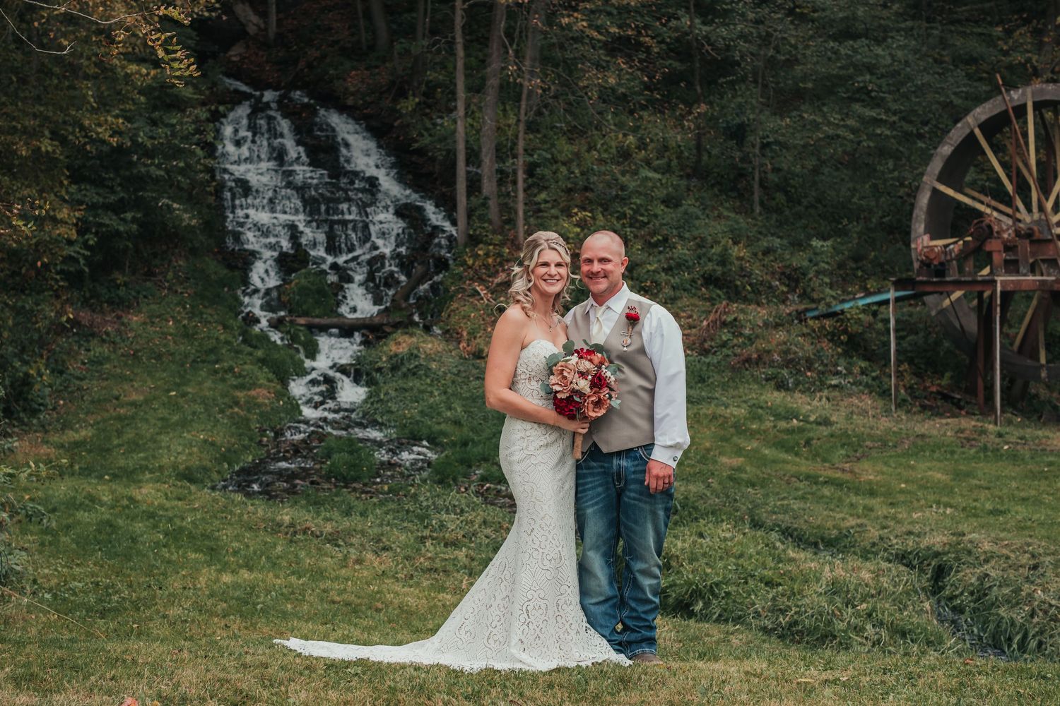 Scenic outdoor wedding photos captured in a lush forest setting at dusk.