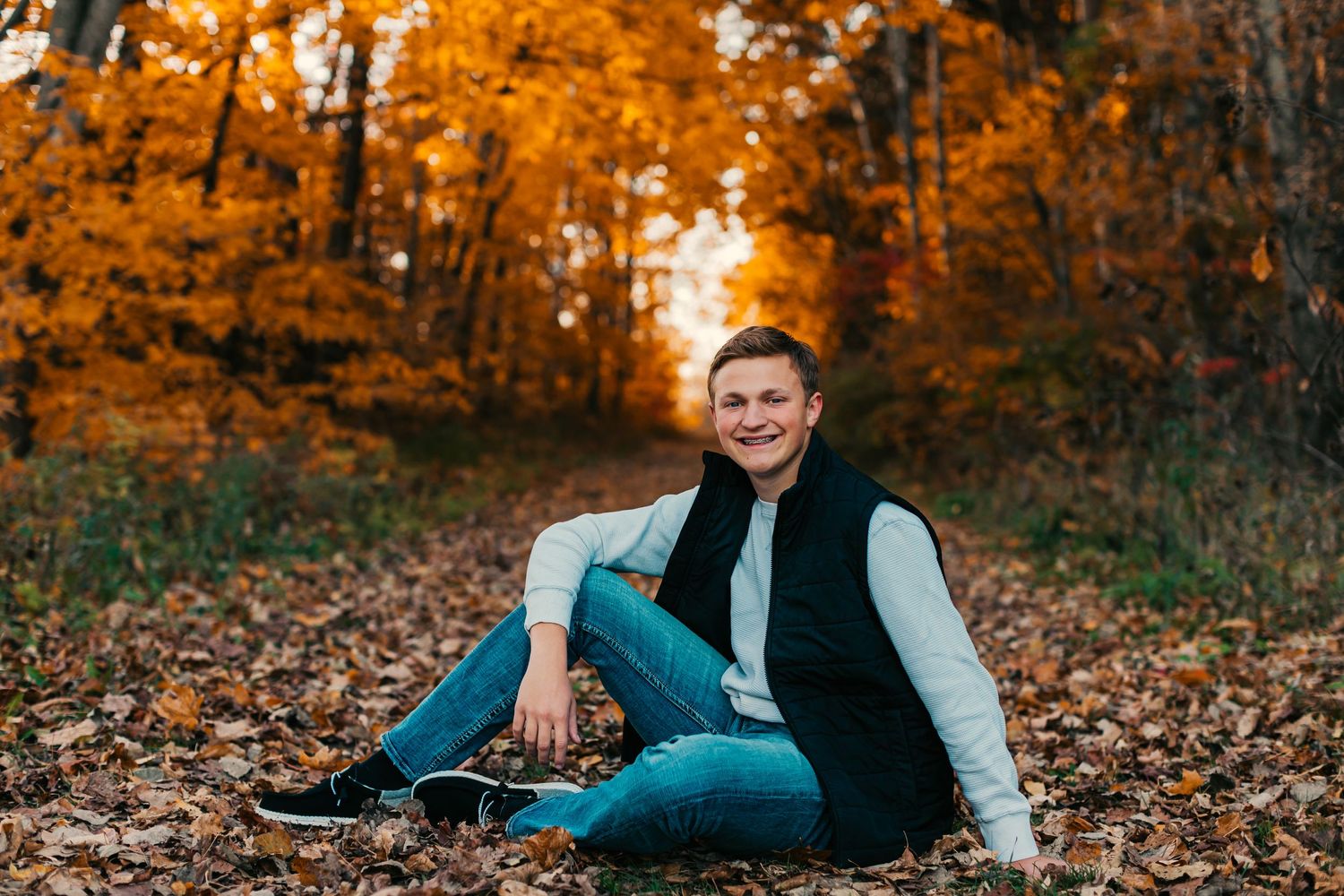 Autumn family photography session with golden leaves and natural lighting.