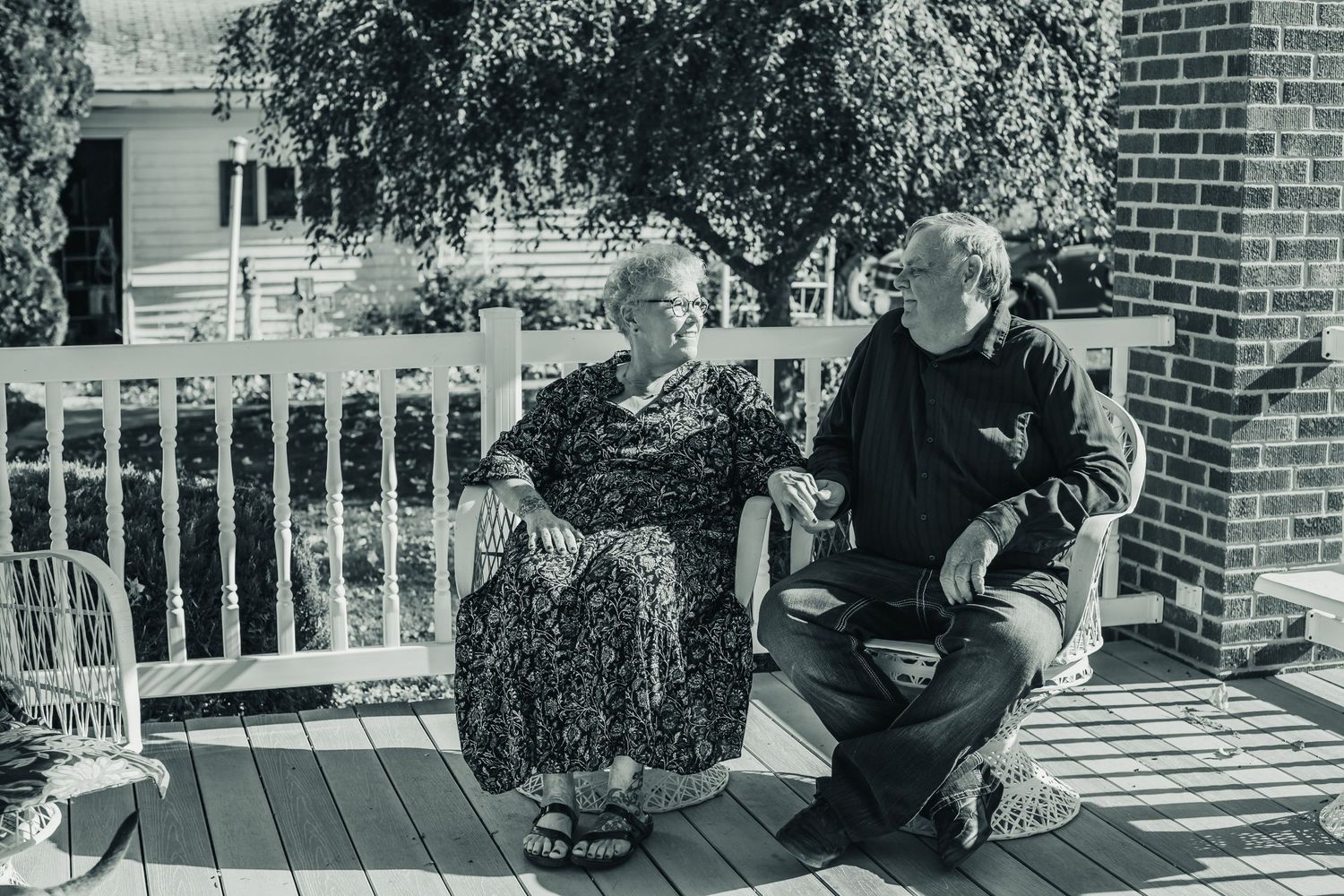 Black and white series of casual moments on a front porch.