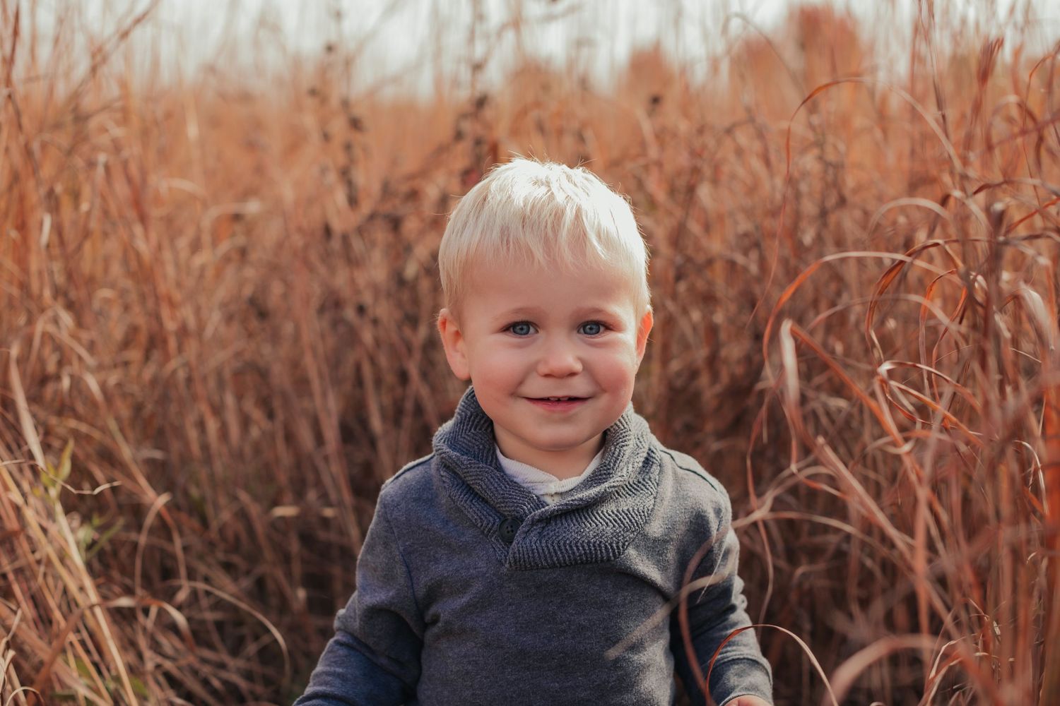 Series of outdoor portraits in autumn with dried grass backdrop.