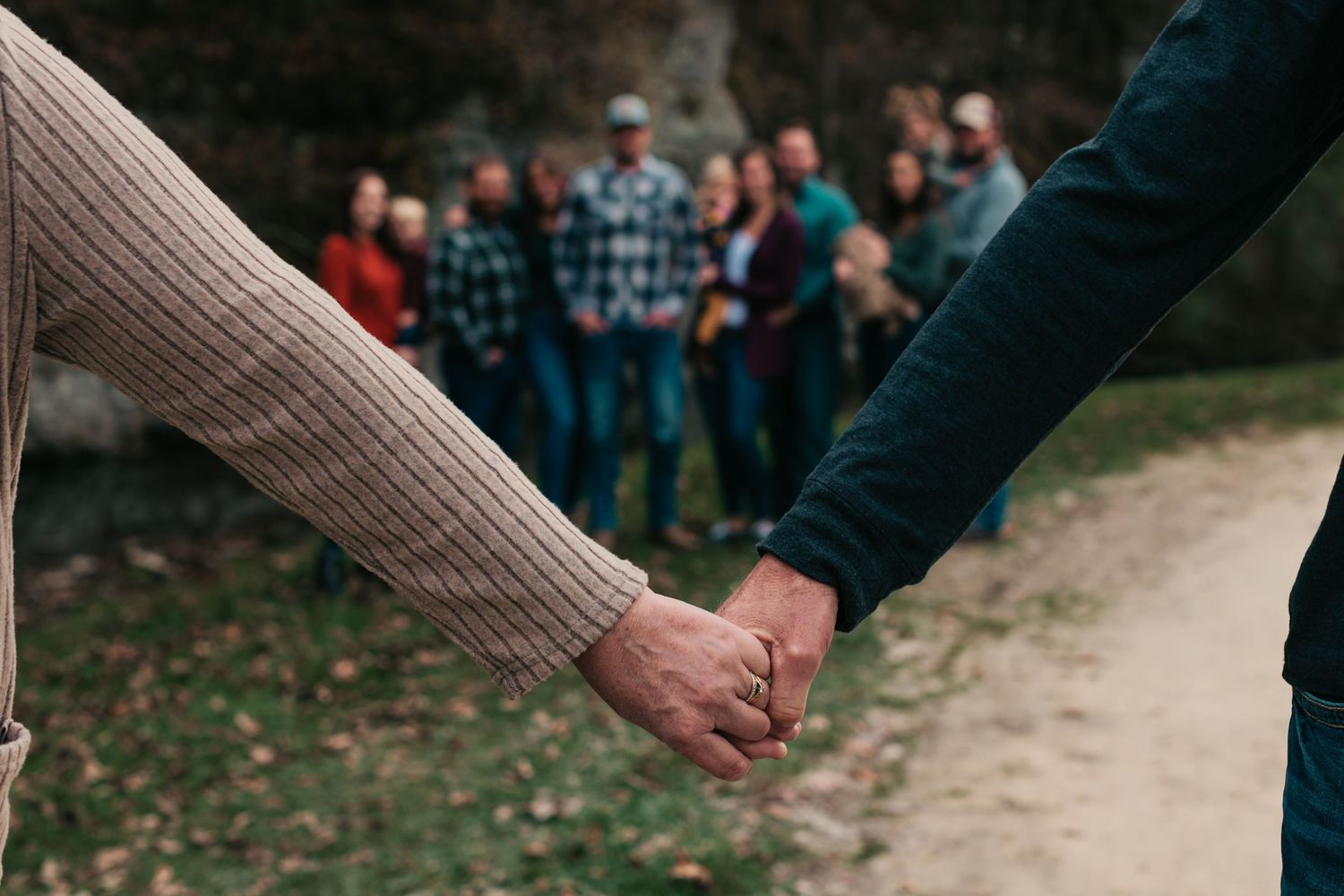 Outdoor walking path with people in casual attire during autumn.