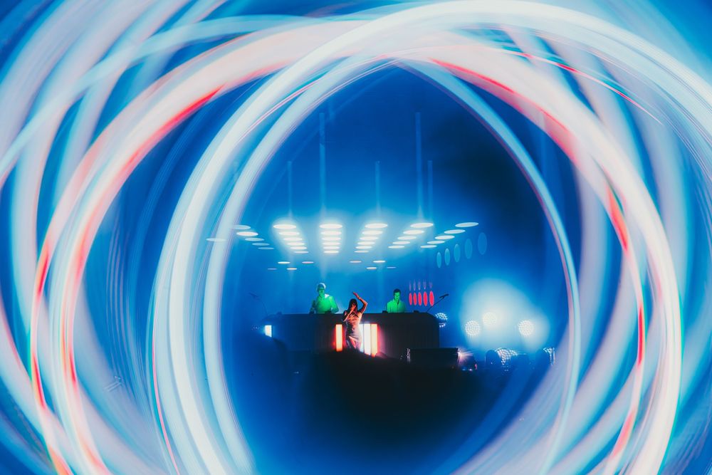 Abstract blue swirling tunnel effect with glowing lights creating a futuristic vortex pattern.