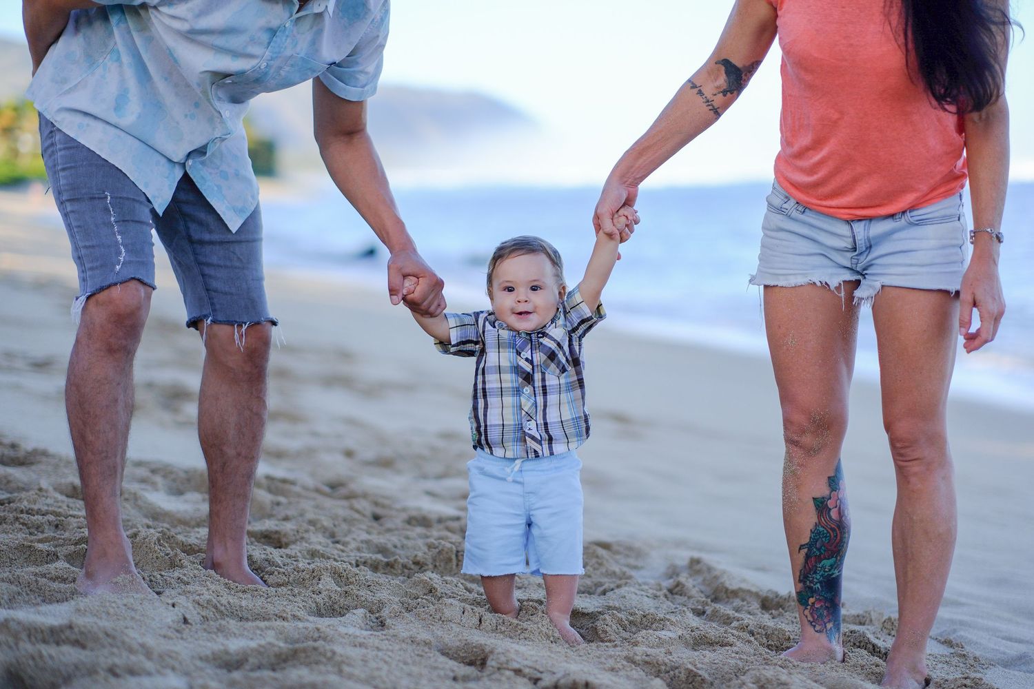 Family members walking together on a sandy beach during sunset family photography session on Oahu North Shore