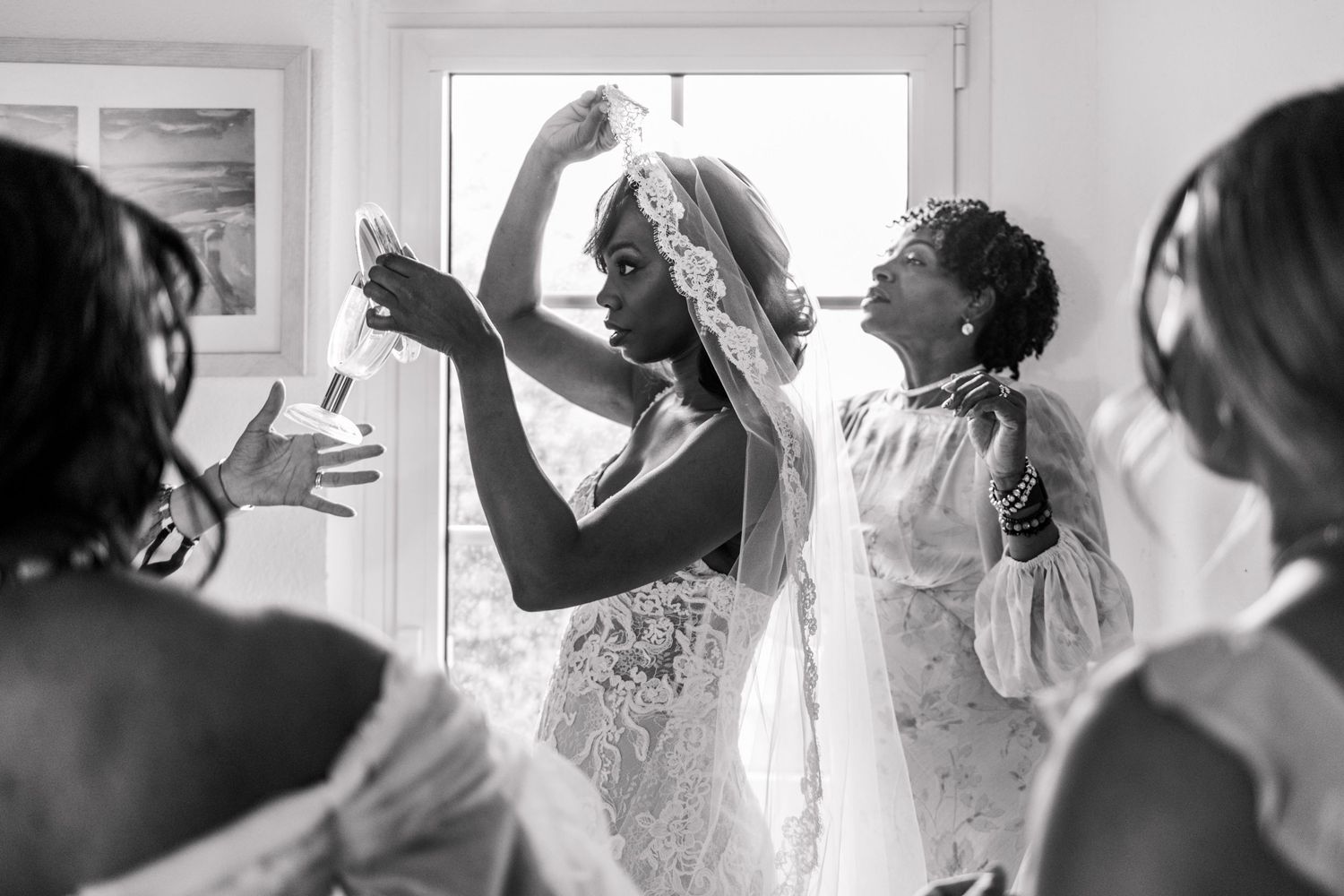 A sequence of black and white photos showing wedding preparation moments with people getting ready by the window.