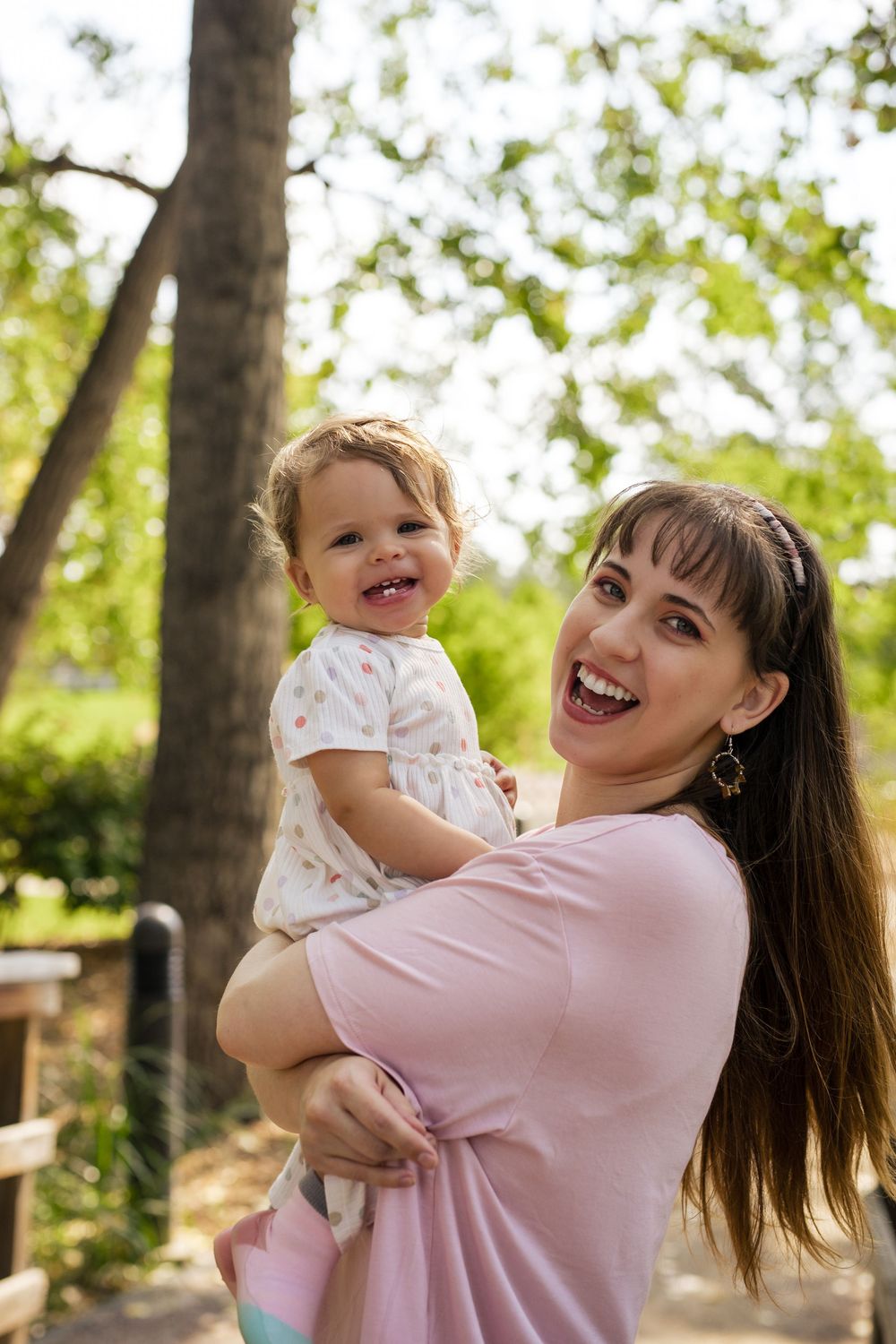 A mother and baby share joyful moments together outdoors in a series of candid photos on a sunny day.