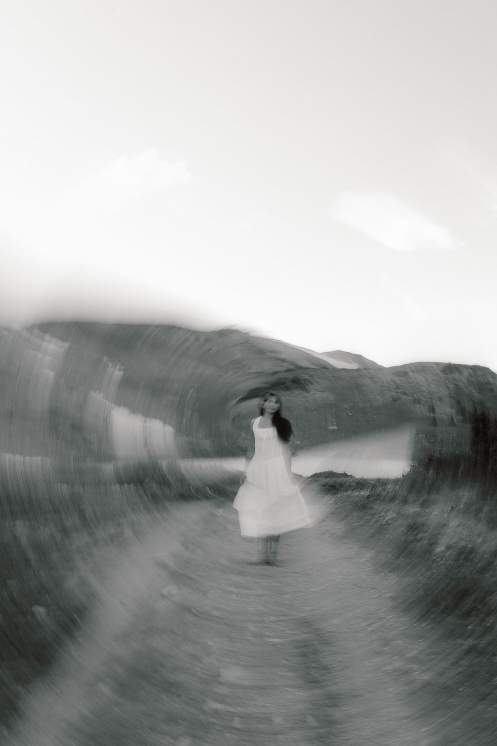 Black and white photo sequence showing a surfer riding through a large wave barrel in dramatic ocean conditions.