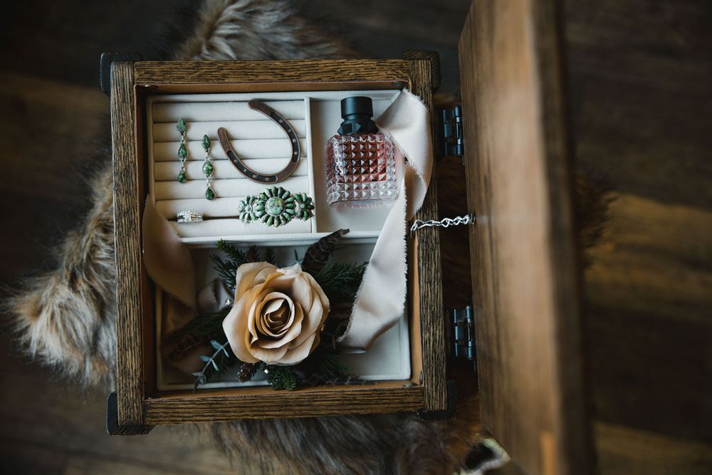 Rustic wooden serving tray with coffee cup and decorative items on a cozy dark wooden table.