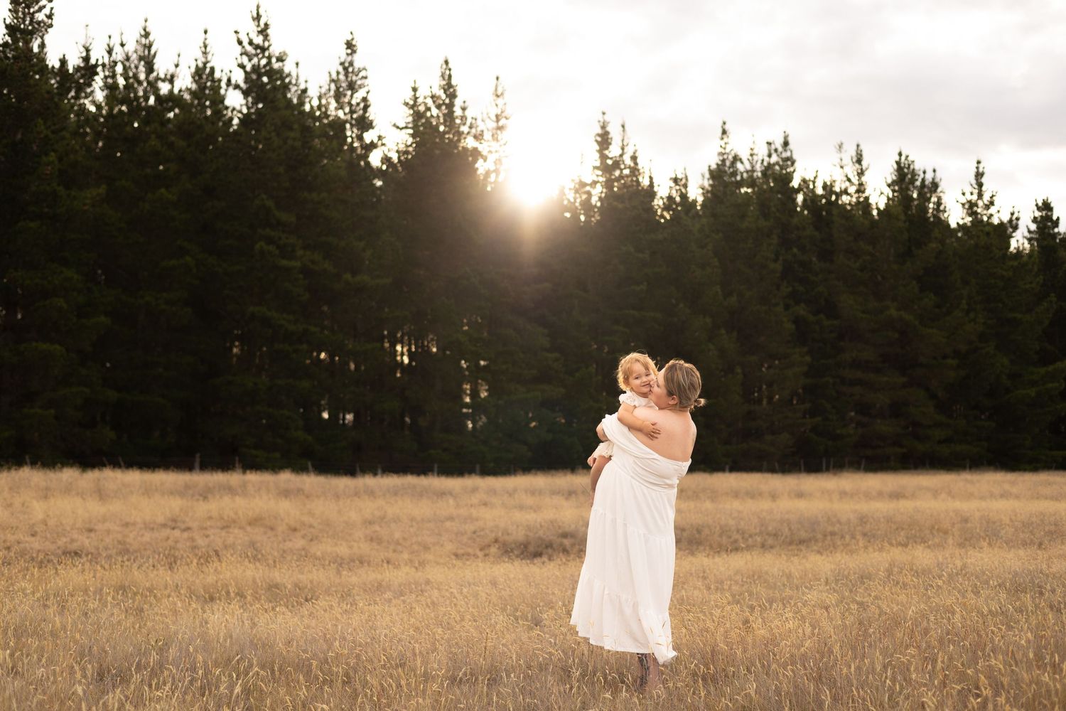 Mum standing and cuddling her daughter during motherhood session at McLeans Island Christchurch