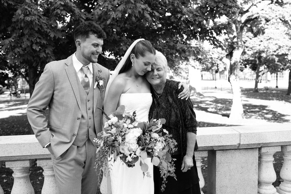 A collection of black and white wedding photographs showing romantic moments between a couple in formal attire outdoors.