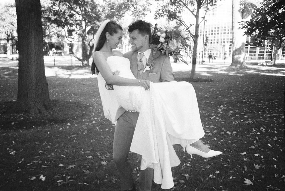 A series of black and white photos showing someone in a white dress sitting on park benches in autumn.
