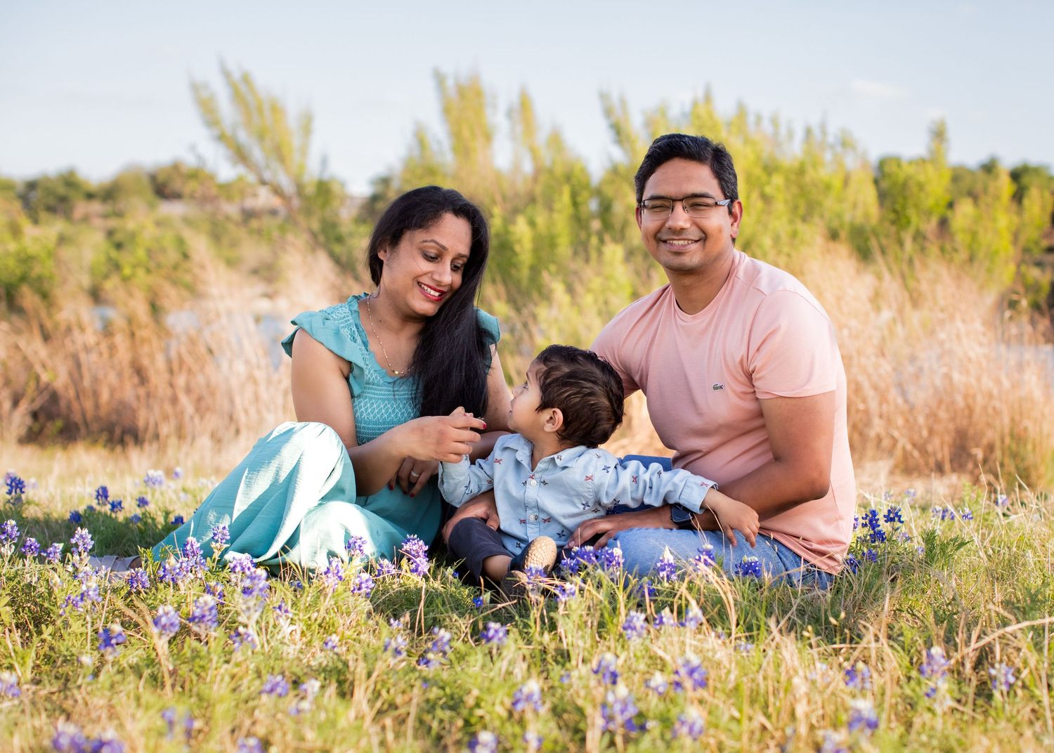 Cedar Park Bluebonnet Mini Session family sitting in bluebonnets in Spring at Brushy Creek Lake Park Texas