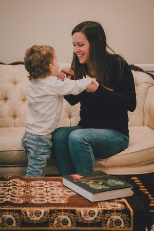 A candid series of photos showing a playful interaction between two people sitting on a beige tufted couch.