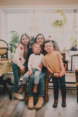 A series of five candid shots showing children sitting together on chairs in a bright indoor setting.