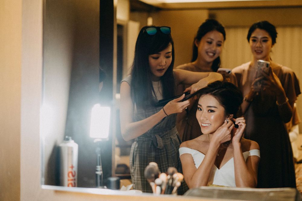 Behind the scenes getting ready moments in a bridal suite with makeup preparations.