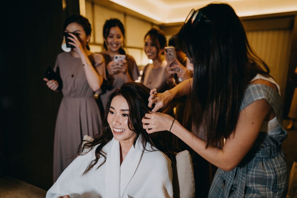 Wedding preparation scene with bridesmaids in a hotel room getting ready for the ceremony.