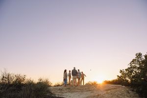 family on top of a canyon overlooking the ocean of southern california