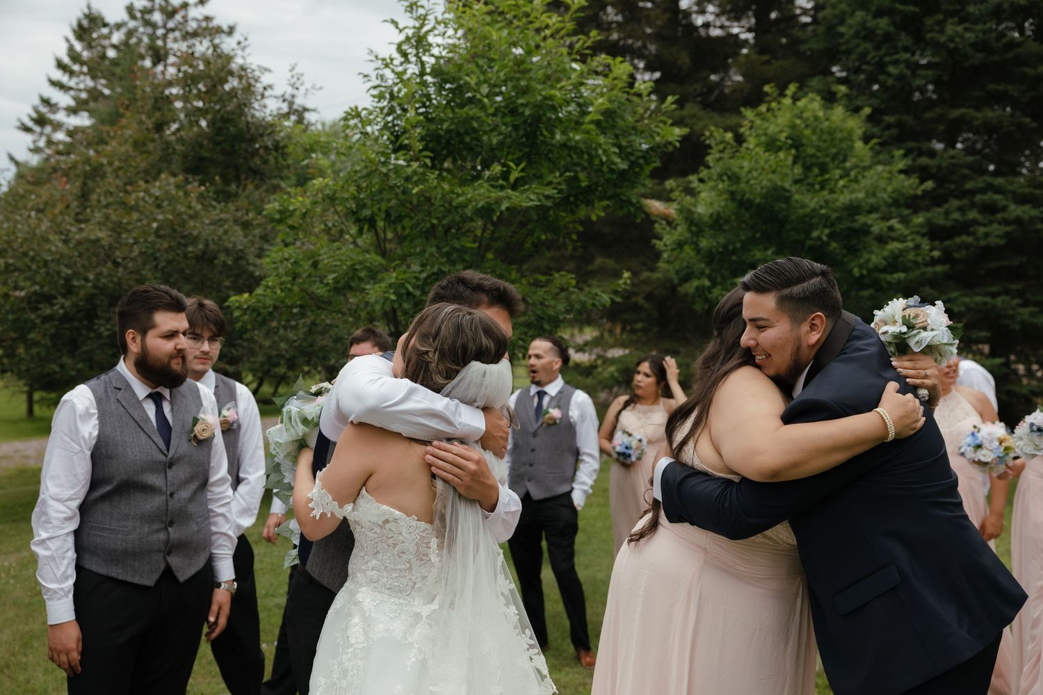 Wedding guests enjoy dancing together in an outdoor garden reception celebration.