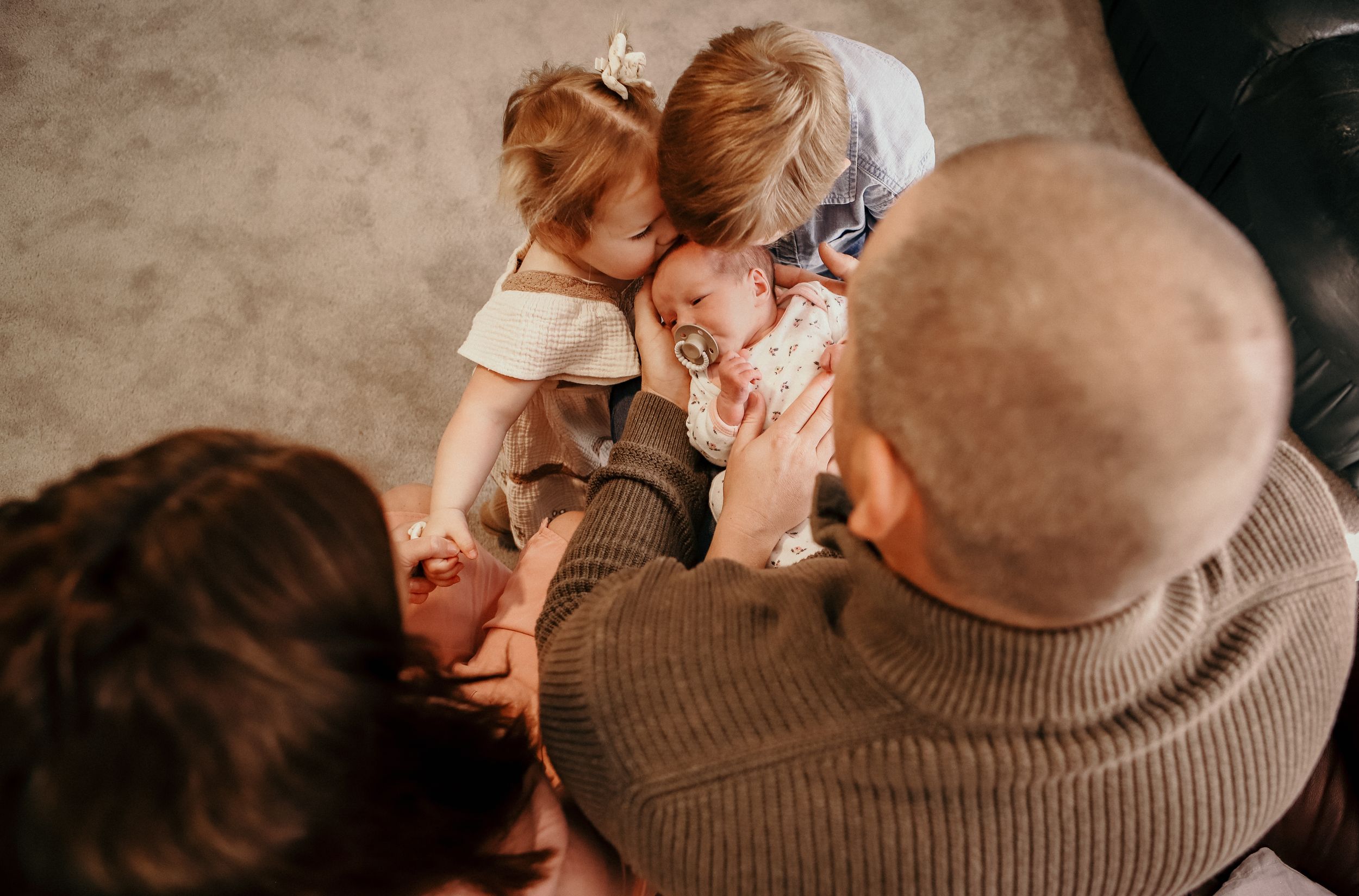 family share intimate moment with newborn baby during a family photoshoot