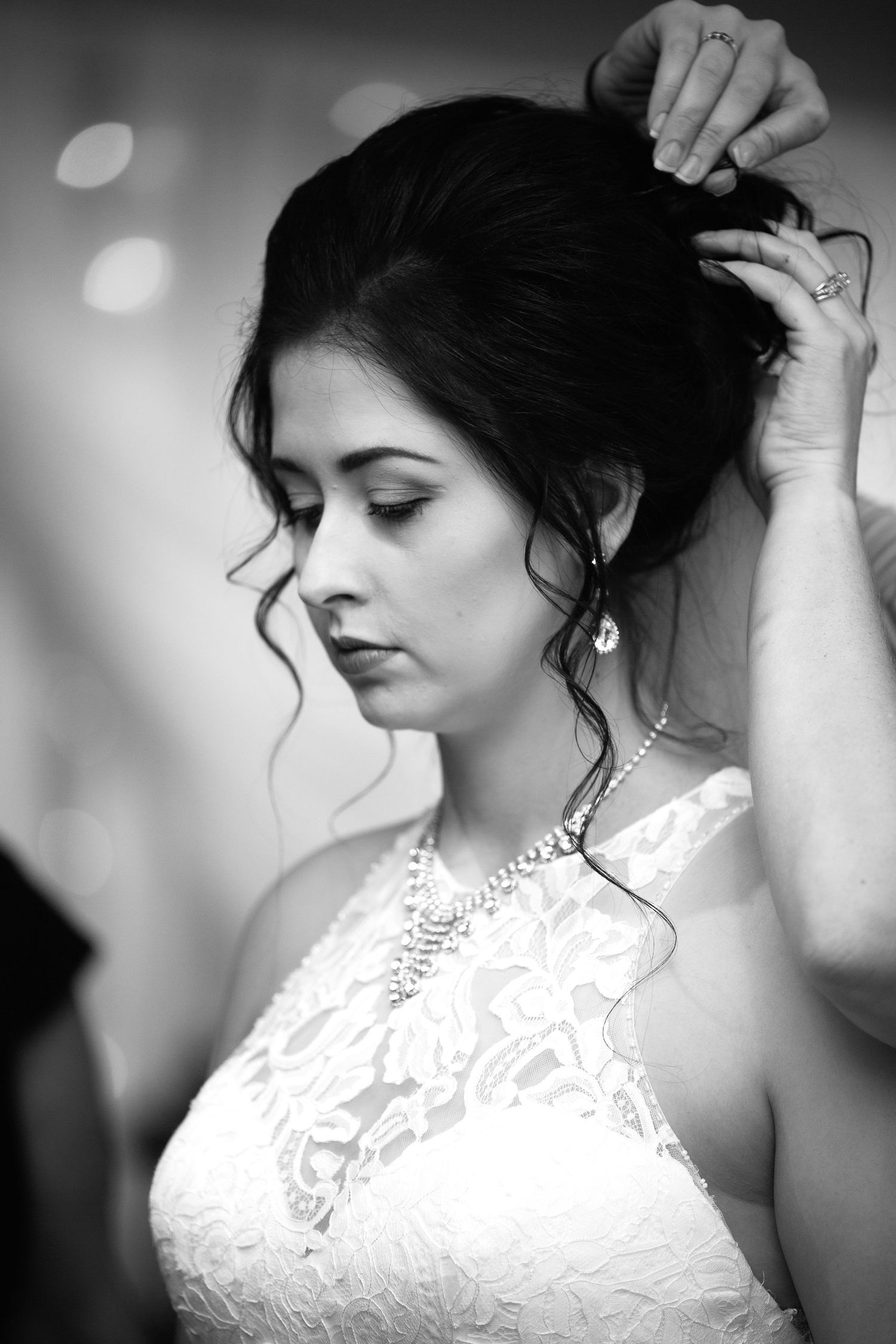 Black and white artistic bridal portraits showing elegant lace dress details and romantic profile poses in strong bokeh lighting.