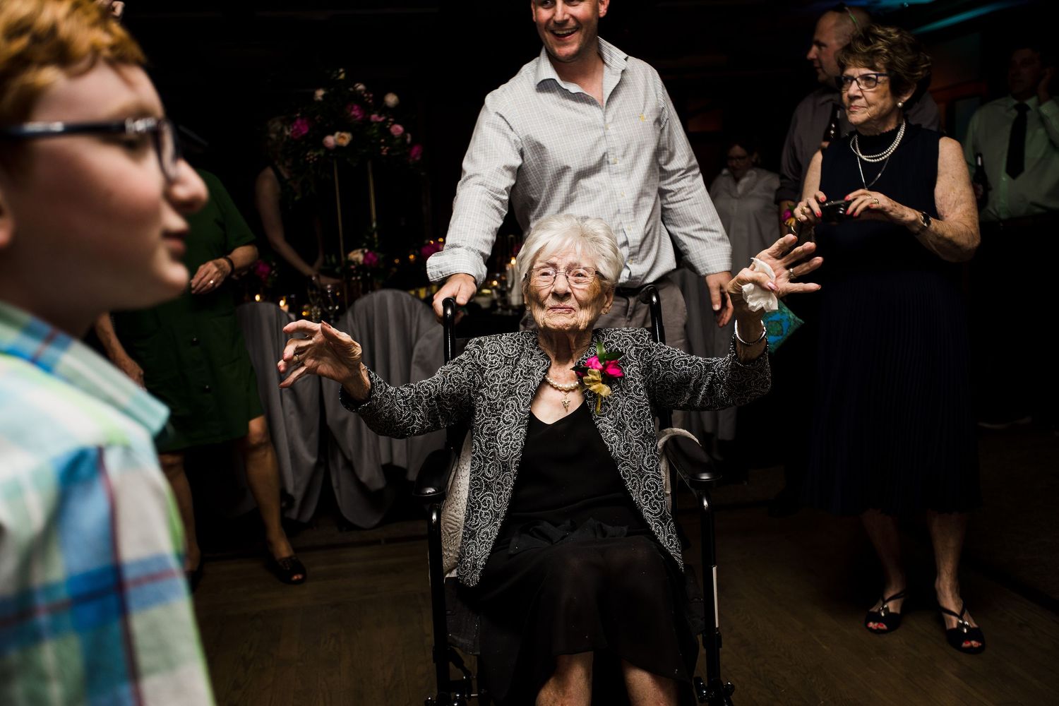 People dance and socialize at what appears to be a nighttime party or celebration event.