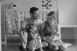A black and white collage of photos shows tender family moments between a parent and child throughout their journey.