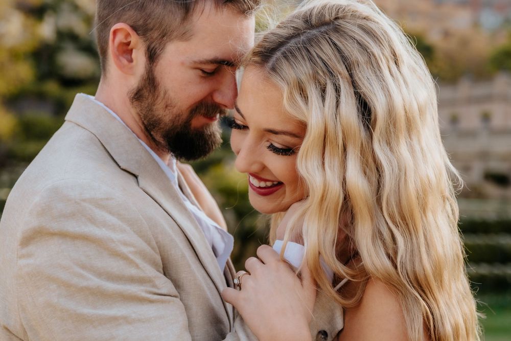 romantic scene of Ashley & Alex celebrating their honeymoon outdoors.