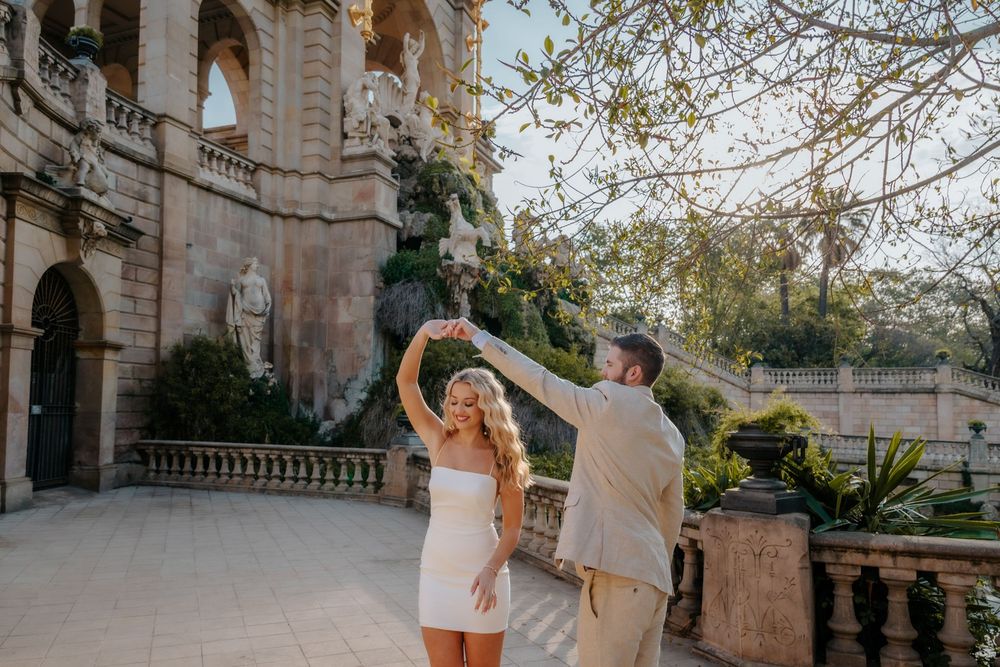 Romantic portrait of the couple framed by park greenery and light.