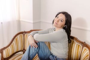 Lifestyle portrait series on vintage striped couch in natural light.