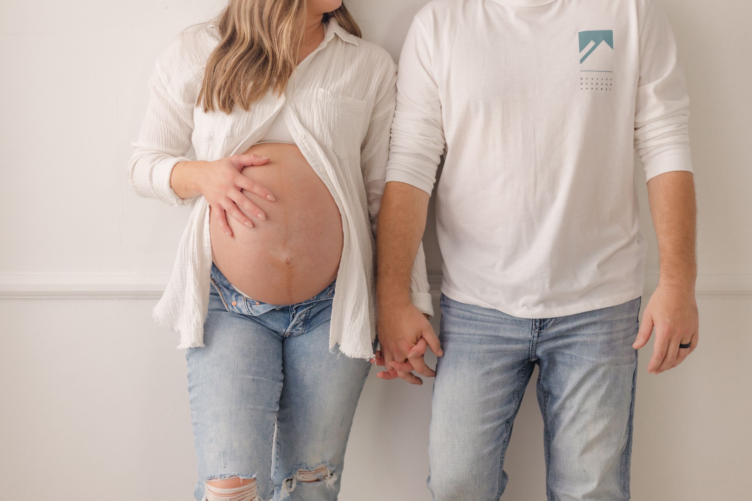 Family portrait series in casual white and denim outfits.