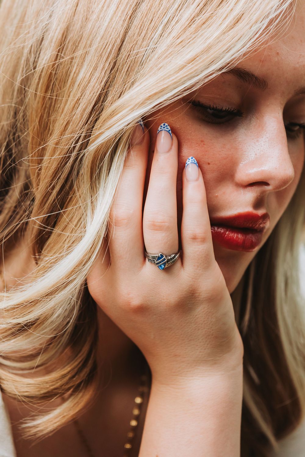 Close-up series showing blonde hair and red lipstick with hand wearing turquoise ring in different poses.