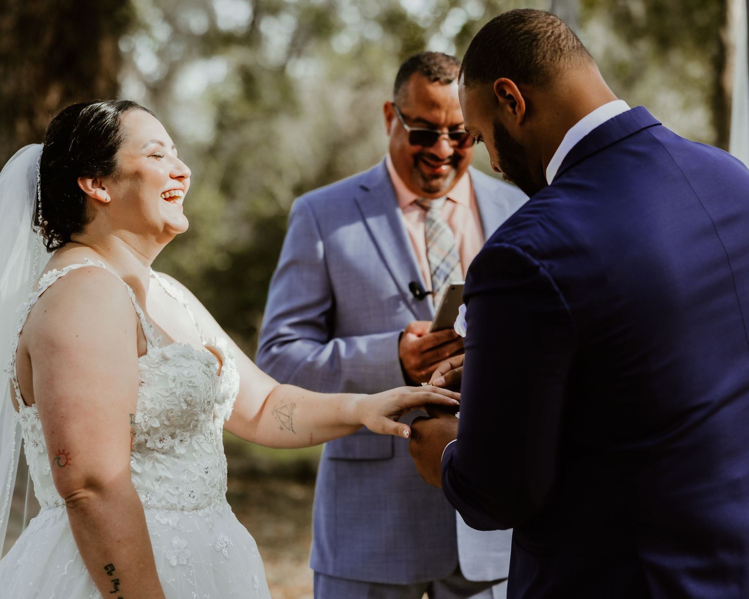 Wedding couple and guests laugh joyfully during outdoor reception celebration captured in candid photo series. Orlando wedding photographer