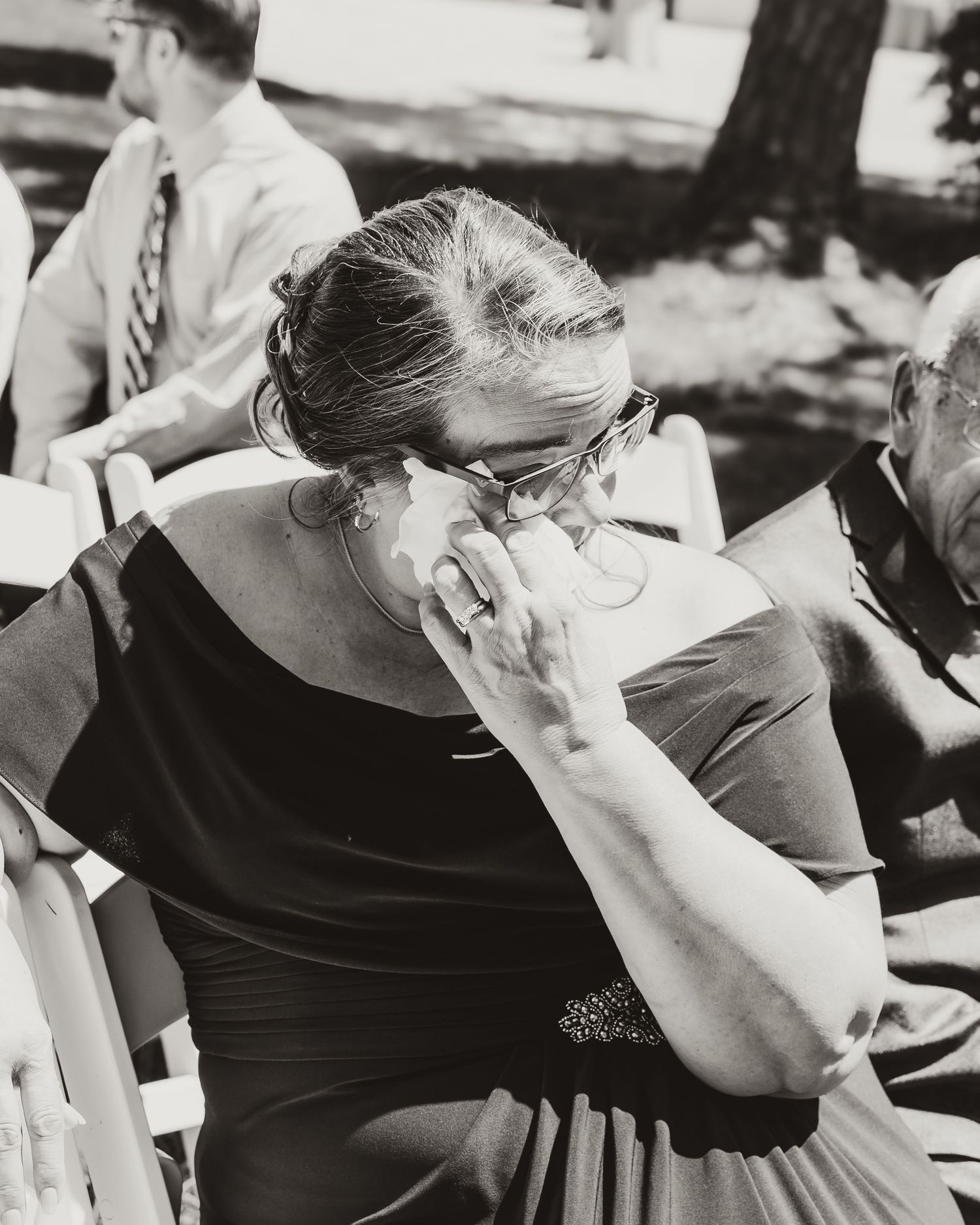 Black and white artistic photograph of mom crying at wedding ceremony. emotional wedding photos. central Florida wedding photo. lithia acres