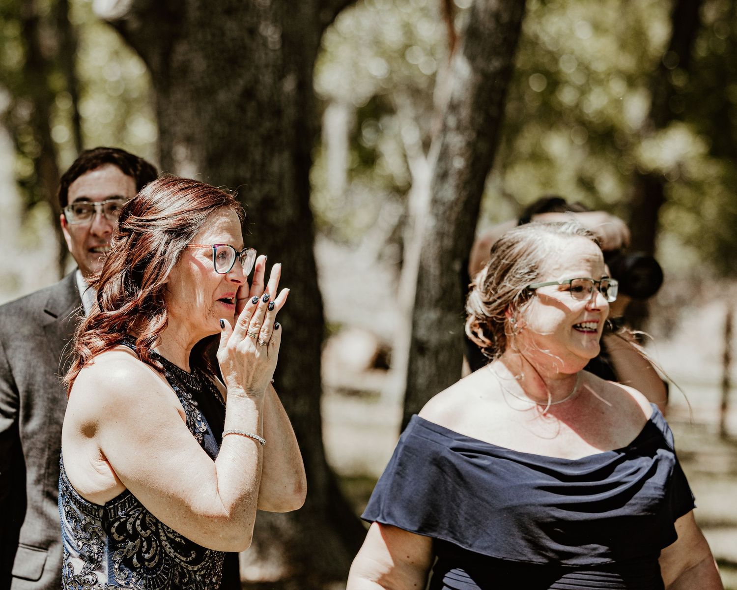 emotional moments during what appears to be a wedding celebration. Mom and mother in law crying at ceremony. Florida wedding photography