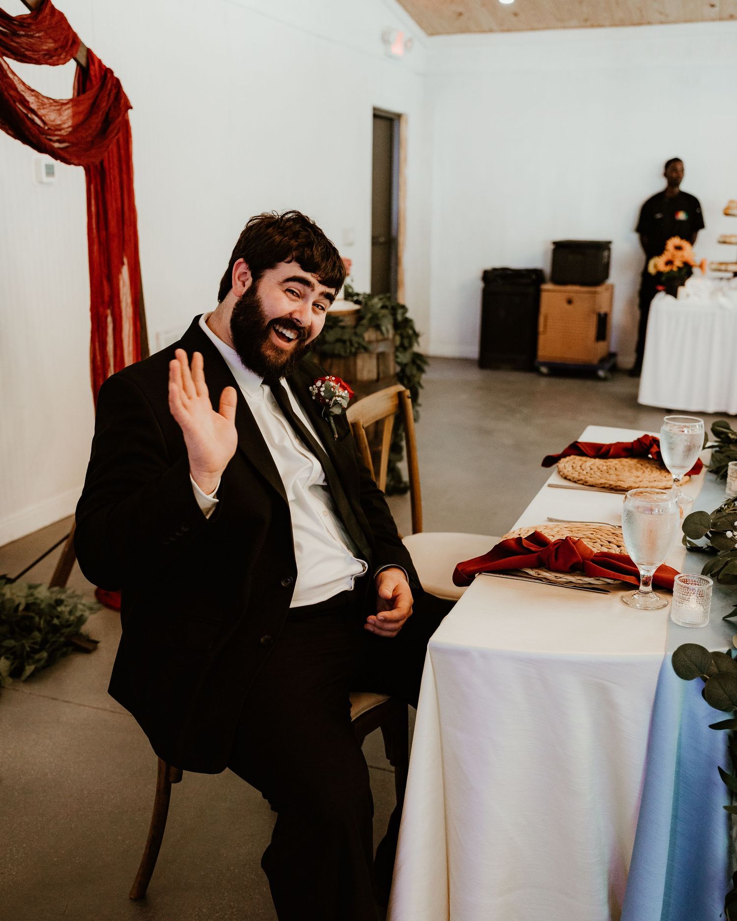 silly photo of groom waving at camera. Florida wedding photographer. lithia acres photos. wedding venue. white barn wedding venue.