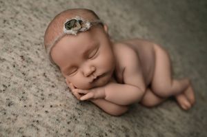 A peaceful sleeping newborn baby in natural lighting photographed in a creative collage style with multiple poses.