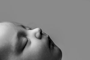 A series of close-up black and white photographs showing a person's chin, mouth, and nose from different angles.