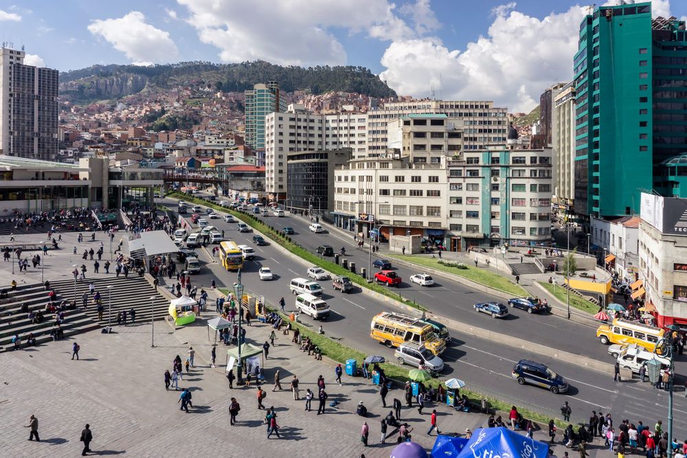 A time-lapse sequence showing a busy city intersection with vehicles and pedestrians moving throughout the day.
