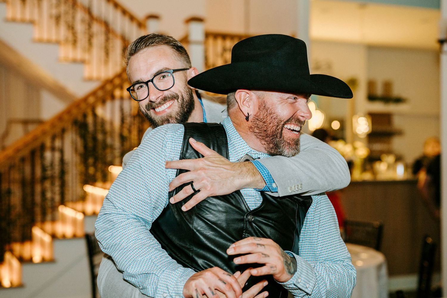 Wedding party members sharing joyful moments in casual attire.