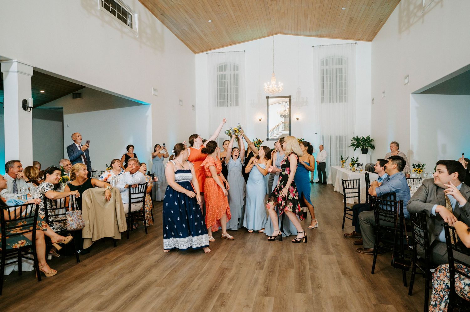 Six candid photos show wedding guests dancing and celebrating together in a reception venue with wooden ceiling.